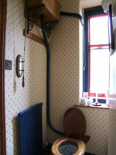 Main loo with wooden cistern